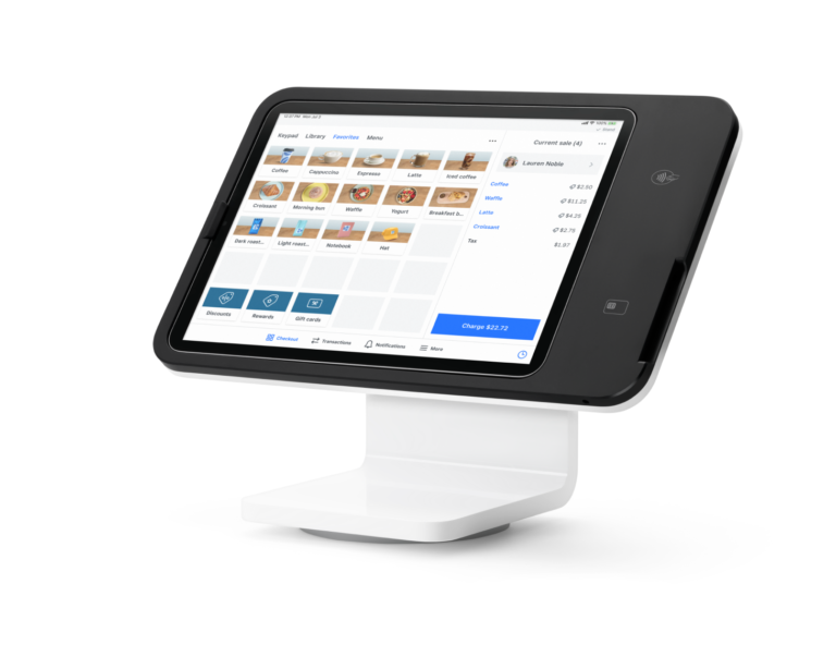 POS touchscreen on a black angled stand showing a grid of coffee items and a checkout total